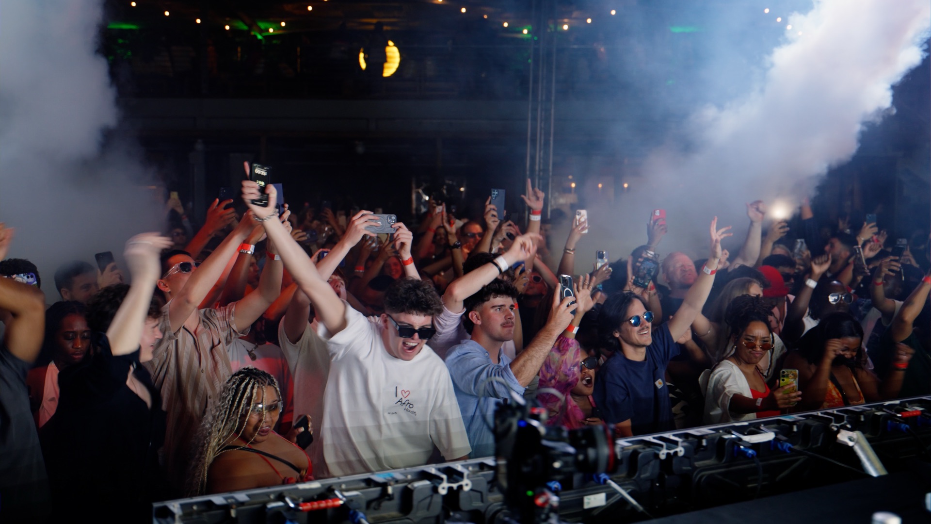 Crowd at a live music event, hands raised